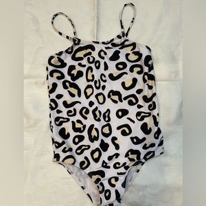 Childs bathing suit size 7-8. Animal print. Small stain shown in picture.